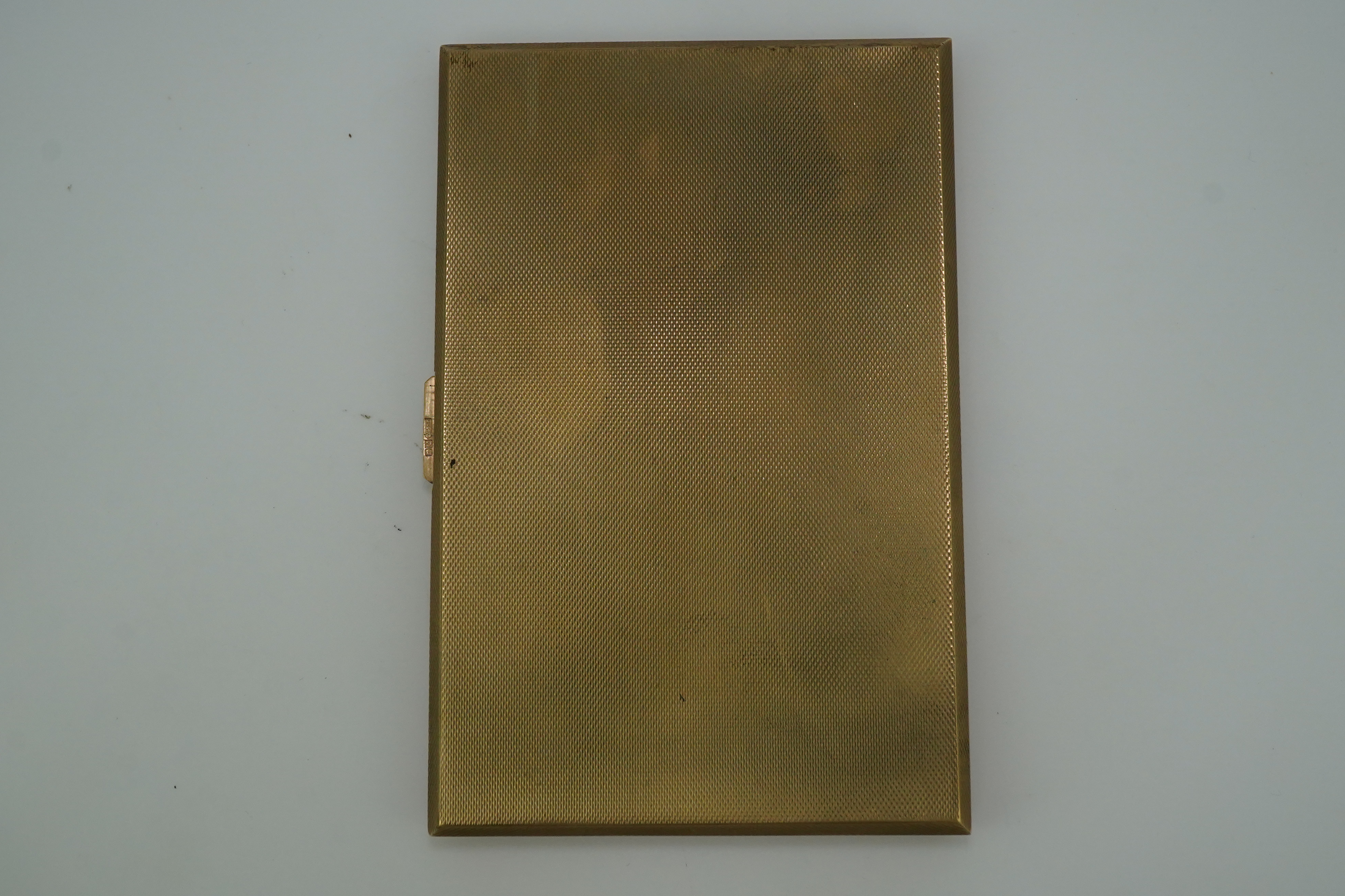 A 9ct gold rectangular cigarette case, circa 1947